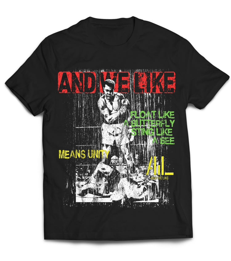 A black T-shirt featuring a distressed graphic of a boxer Muhammad Ali in action against a backdrop of rain. The text reads "AND WE LIKE" in red, "MEANS UNITY" in yellow, "Float like a Butterfly, Sting like a Bee" in white, and "ALL LIKE" in yellow.
